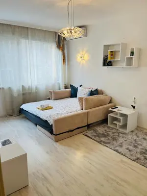 a living room with a bed and a couch at Sofiaway Central Apartment in Sofia