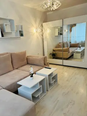 a living room with a couch and two tables at Sofiaway Central Apartment in Sofia