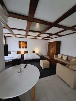 a living room with a white table and a couch at Цветелина и Митко in Bansko