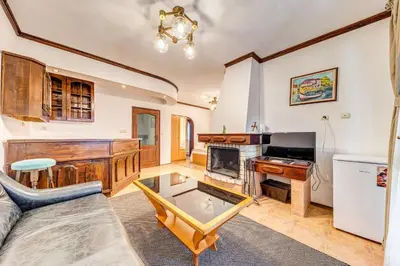 a living room with a couch and a table at Комплекс Райковски Ливади in Pamporovo