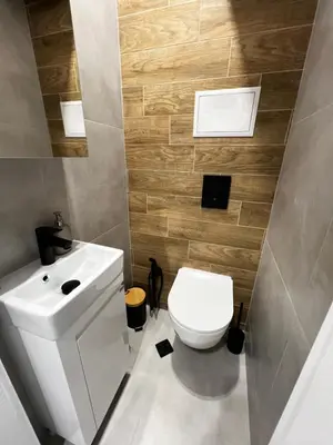 a bathroom with a white toilet and a sink at Monaco 100 Sq M 3BDR Apt on Oborishte street with WiFi in Sofia