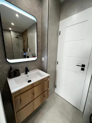 a bathroom with a white sink and a mirror at Monaco 100 Sq M 3BDR Apt on Oborishte street with WiFi in Sofia
