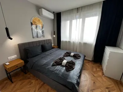 a bedroom with a bed with two towels on it at Monaco 100 Sq M 3BDR Apt on Oborishte street with WiFi in Sofia