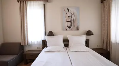 a bedroom with a bed with a horse picture on the wall at Комплекс Белите скали in Gaytaninovo