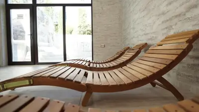a wooden bench in a room with a window at Комплекс Белите скали in Gaytaninovo