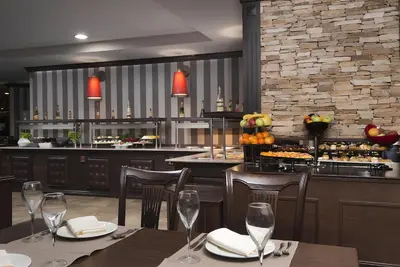 a restaurant with tables and chairs and a bar at Private Studio in Royal Park in Bansko
