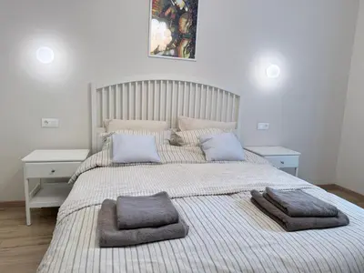 a bedroom with a large bed with two pillows on it at New top center cozy 3 bedroom apartment in Sofia
