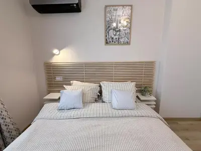 a bedroom with a large bed with white sheets and pillows at New top center cozy 3 bedroom apartment in Sofia