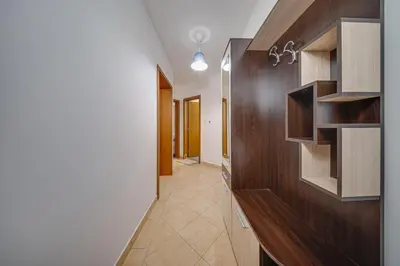 a hallway with wooden cabinets and a hallway with a hallway at Modern 1-Bedroom Apartment in Absolute City Center in Sofia