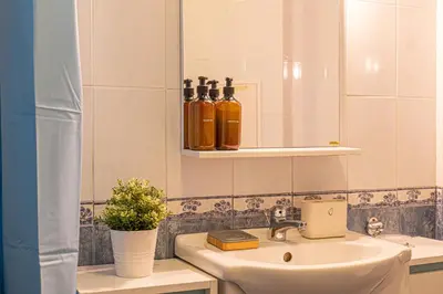 a bathroom with a sink and a mirror at Modern 1-Bedroom Apartment in Absolute City Center in Sofia