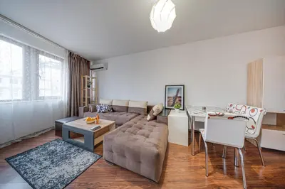 a living room with a couch and a table at Modern 1-Bedroom Apartment in Absolute City Center in Sofia