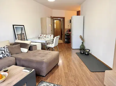 a living room with a couch and a white refrigerator at Modern 1-Bedroom Apartment in Absolute City Center in Sofia