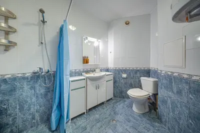 a bathroom with a toilet and a sink and a shower at Modern 1-Bedroom Apartment in Absolute City Center in Sofia