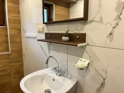 a bathroom with a sink and a mirror at Стаи за гости Царвулджиеви in Koprivshtitsa