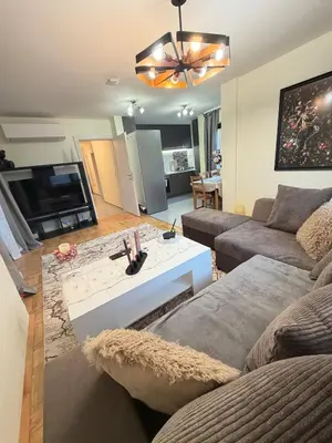 a living room with a couch and a table at New cozy 3 bedroom apartment 90m2 in Sofia