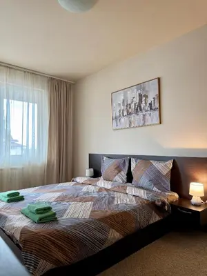 a bedroom with a bed with two towels on it at Gino's place Home2Host in Bansko