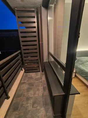 a room with a staircase next to a bed at Sasha Yo in Razlog