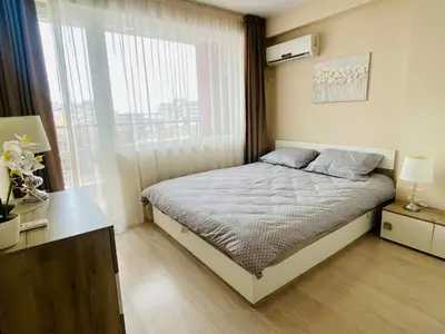 a small bedroom with a bed and a window at Old Town Prime Apartment & Parking in Plovdiv