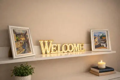 a shelf with two pictures and a welcome sign at Old Town Prime Apartment & Parking in Plovdiv