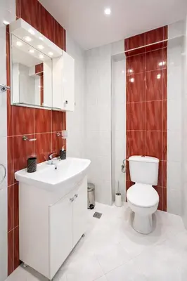 a white bathroom with a toilet and a sink at Old Town Prime Apartment & Parking in Plovdiv