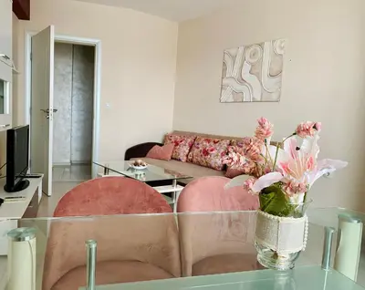 a living room with a couch and a glass table at Old Town Prime Apartment & Parking in Plovdiv