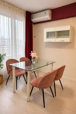 a dining room with a glass table and chairs at Old Town Prime Apartment & Parking in Plovdiv