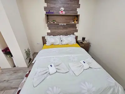 a bedroom with a bed with two towels on it at Desitas home in Plovdiv