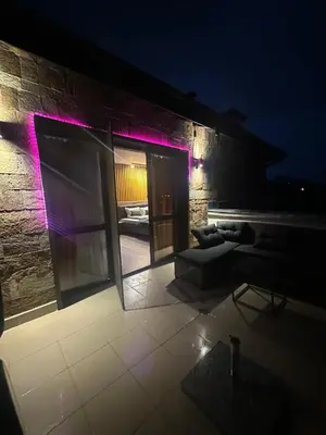 a room with a couch and a building at night at Prime Mountain View Bansko in Bansko