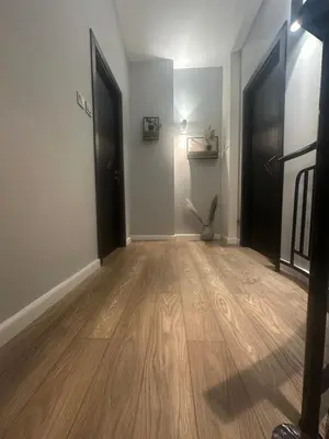 an empty room with two black doors and a wooden floor at Prime Mountain View Bansko in Bansko