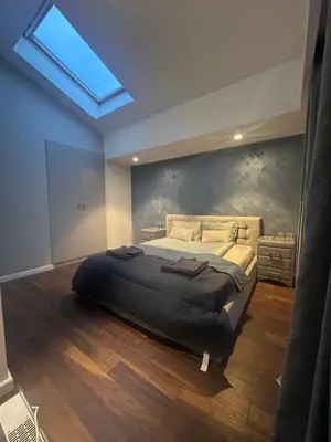 a bedroom with a large bed with a skylight at Prime Mountain View Bansko in Bansko