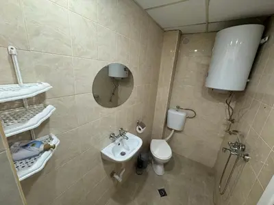 a small bathroom with a toilet and a sink at Berta Gardens 1 in Sandanski