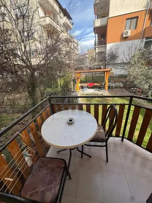 a table and chairs on a balcony with a fountain at Berta Gardens 1 in Sandanski
