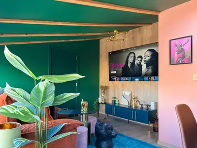 a living room with green walls and a flat screen tv at Central 2BR with Designer Interior and Work Desk in Sofia