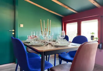 a dining room with a table and blue chairs at Central 2BR with Designer Interior and Work Desk in Sofia