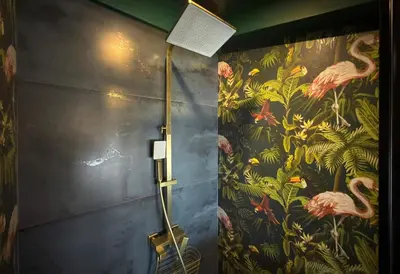 a shower in a bathroom with a floral wallpaper at Central 2BR with Designer Interior and Work Desk in Sofia