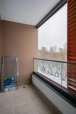 a room with a balcony with a large window at Spacious 2BR Apartment - Modern Design in Sofia