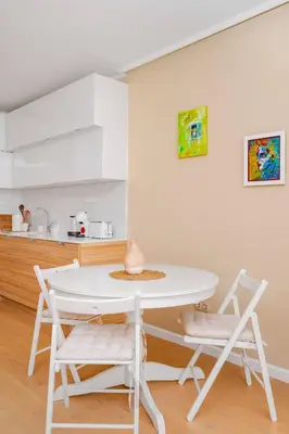 a kitchen with a white table and two chairs at Sunny 1BR with Balcony in Sofia