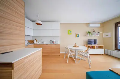 a kitchen and dining room with a table and chairs at Sunny 1BR with Balcony in Sofia