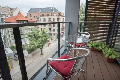 a balcony with a table and chairs and a view of a street at 5 minutes sity center plus parking in Plovdiv