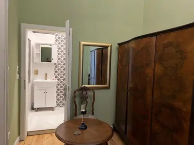 a room with a wooden table and a mirror at Belview Apartment with Panoramic Old Town View in Plovdiv