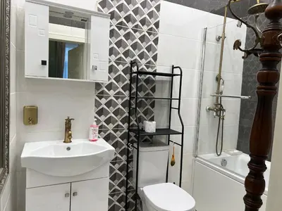 a bathroom with a sink and a toilet and a mirror at Belview Apartment with Panoramic Old Town View in Plovdiv