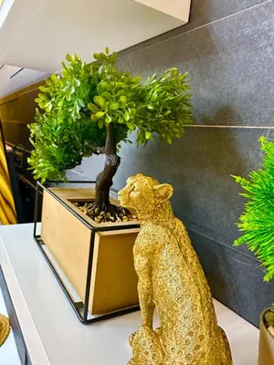 a statue of a bear next to a bonsai tree at Regatta Park 1BR Exclusive Suite Parking Included in Plovdiv