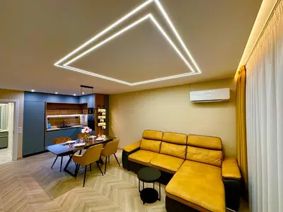a living room with a couch and a table at Regatta Park 1BR Exclusive Suite Parking Included in Plovdiv