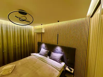 a bedroom with a large bed in a room at Regatta Park 1BR Exclusive Suite Parking Included in Plovdiv