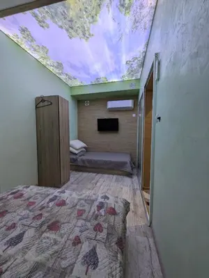 a bedroom with a bed and a skylight on the ceiling at Наслада in Panagyurishte