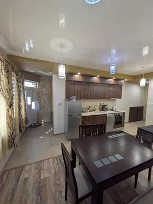 a kitchen and a dining room with a table and chairs at Наслада in Panagyurishte