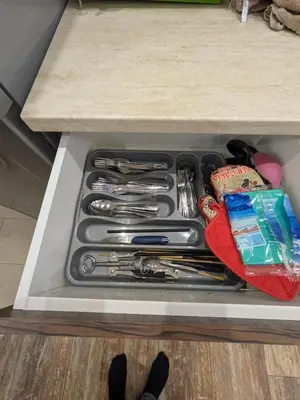 a drawer filled with cooking utensils on a counter at Наслада in Panagyurishte