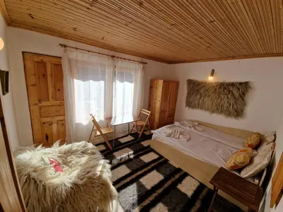 a bedroom with a large bed and a window at The House in Stoykite