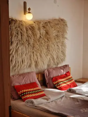 a bedroom with a bed with two pillows on it at The House in Stoykite