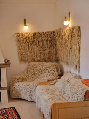 a room with two beds covered in hay at The House in Stoykite